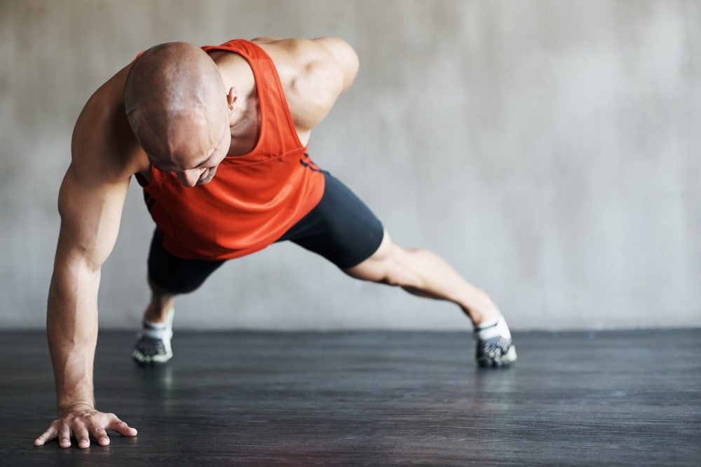 Stepping up his fitness routine. Shot of a man working out at the gym.